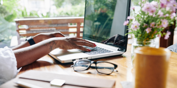 A woman working on her computer creating a moving budget sheet