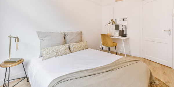 neutral staged bedroom with beige pillows